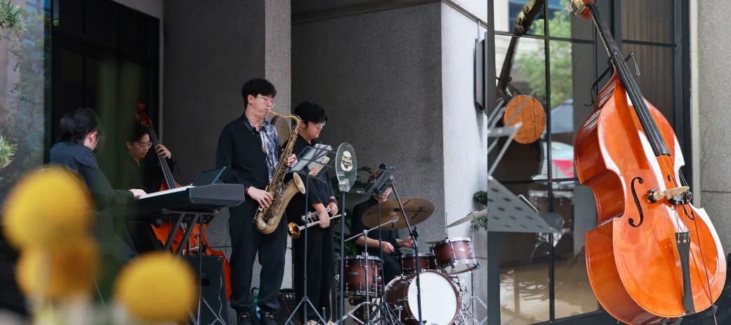 Jazz musicians performing at a hotel beside an upright bass